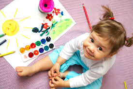 Toddler girl painting the sun